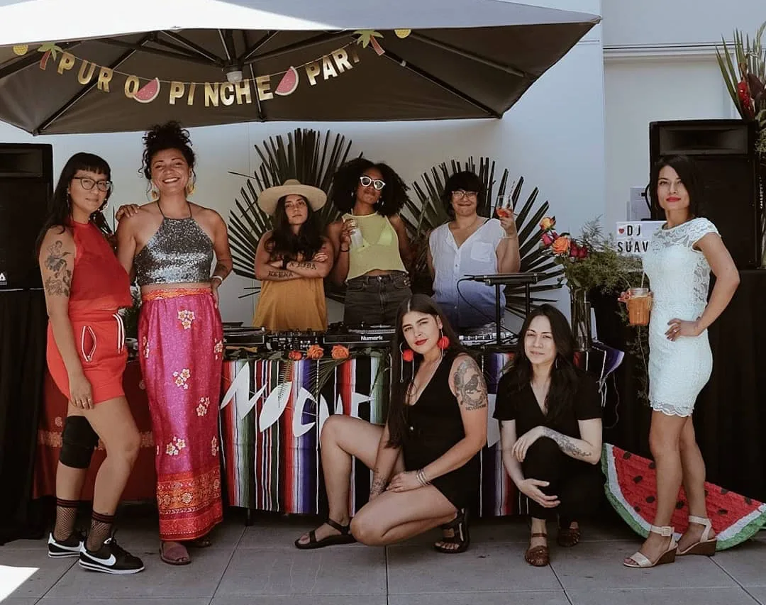 Noche Libre Latina DJ collective members posing. There are 8 femmes.
